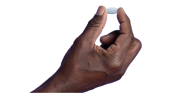 A close-up of a person's hand holding a single white ERLEADA 240 mg tablet, marked with the code 'E240'